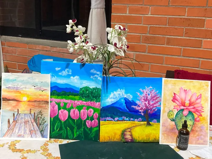 Pinturas de alumnas sobre una mesa